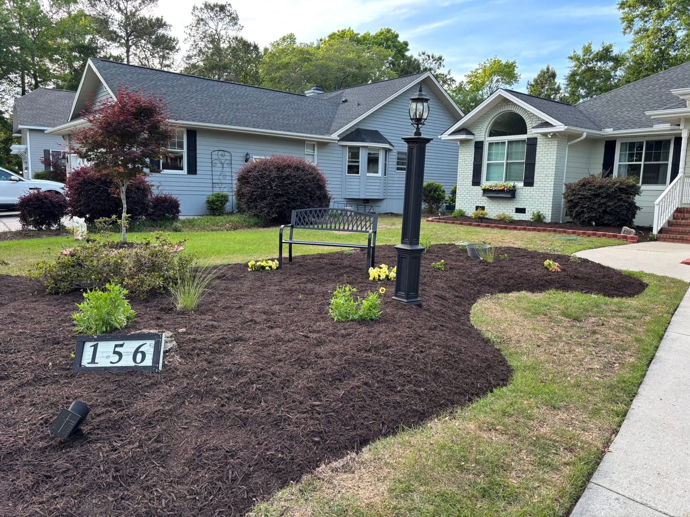 Landscaped front yard with fresh mulch beds and plantings