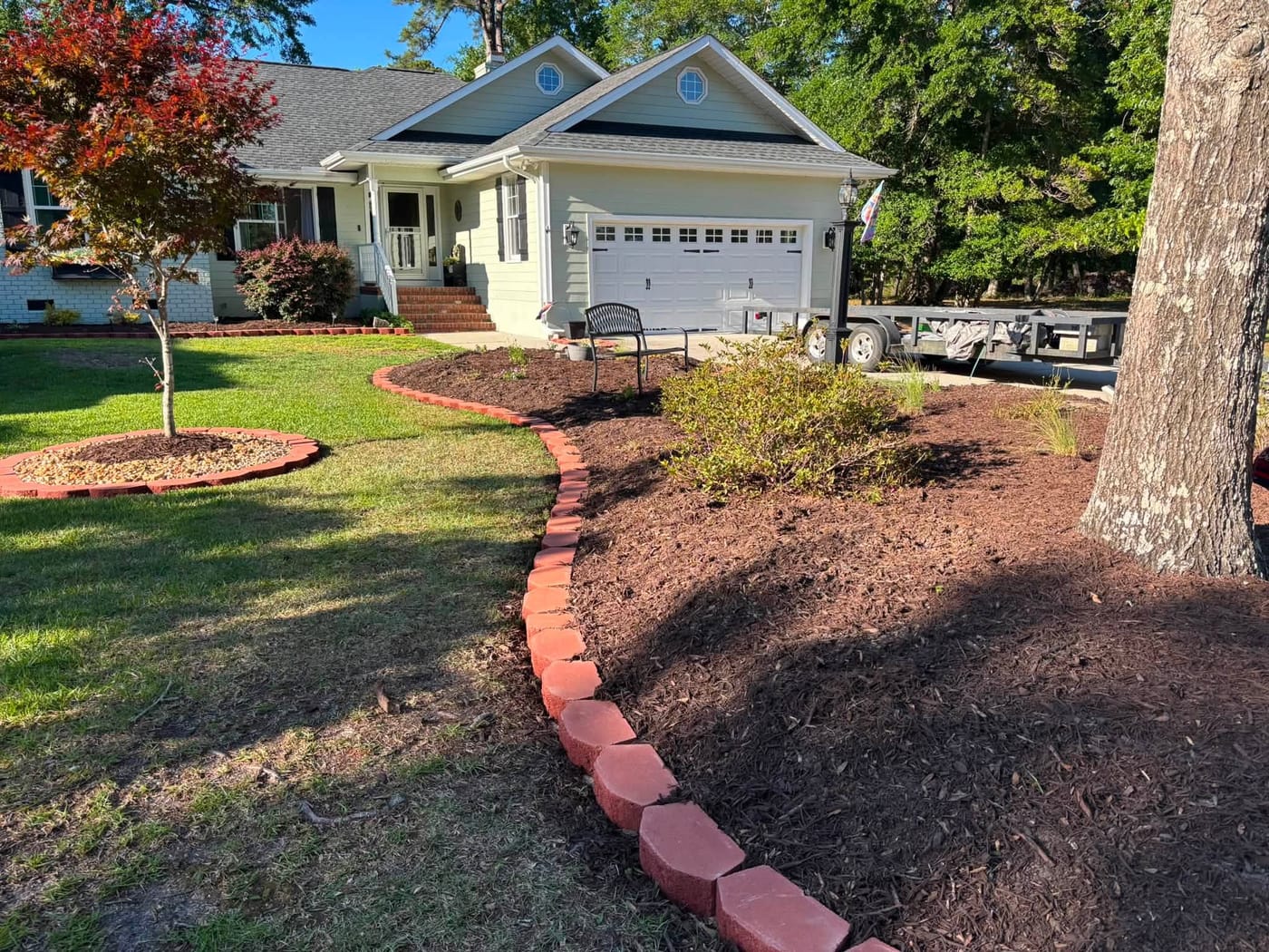 Fresh dark mulch beds with clean edging