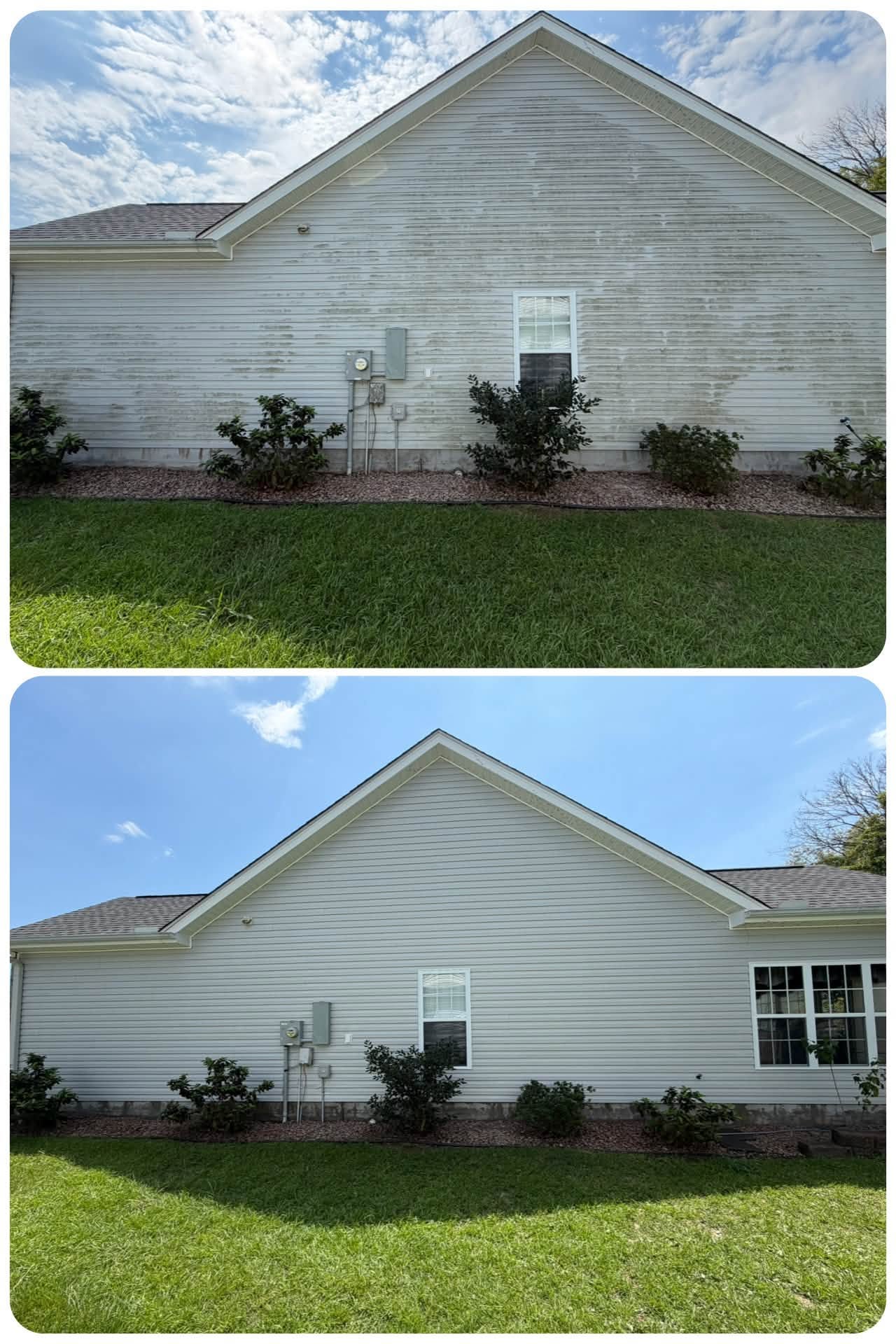 Tidy landscaped bed with fresh shrubs and green lawn along a brick home
